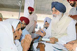 Chief Minister Parkash Singh Badal redresses the grievances of villagers at a sangat darshan programme at Valtoha in Tarn Taran