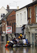 Men being rescued from a flooded building in Evesham, central England, on Saturday.