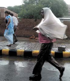 A man saves himself from rain in the Capital on Monday.
