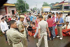 The protesters block traffic in front of the police station