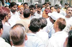 MC employees express their solidarity with the families of the sewer men who choked to death, at the Civil Hospital in Ludhiana
