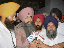 Policemen escort Daljit Singh Bittu to a local court in Fatehgarh Sahib on Monday. 