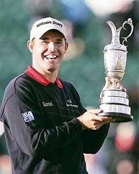 Irelands Padraig Harrington holds the Claret Jug trophy after winning the British Open Golf Championship in Carnoustie, Scotland