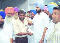 Minister Bikram Singh Majithia distributes cheque among fire vicitms in Amritsar