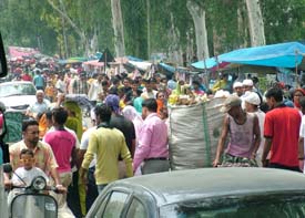 The Jalandhar-Kapurthala road witnesses a complete traffic chaos because of stalls put up all along the highway near Wadala level crossing, on the occasion of the Traggian Wala fair, on Tuesday.