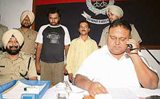 Two of the persons, who used to pose as Sukhbir Badals OSD, in police custody at the Police Lines in Patiala on Tuesday. 