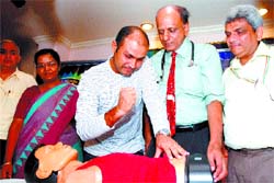 Cricketer Virender Sehwag with Dr K. K. Aggarwal, president of Heartcare Foundation of India (2nd right) gives a demonstration on sudden cardiac arrest and its prevention in the Capital 