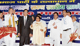 UP Chief Minister Mayawati holds aloft the sword presented by Congress dissident MLA Vijay Singh Mankotia during a rally at Kangra on Thursday.