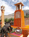 An Army officer places a wreath at the war memorial.