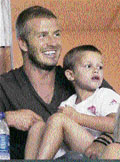 Los Angeles Galaxys soccer star David Beckham and his son Romeo watch his team play against CF Pachuca in Carson, California.