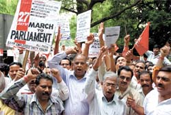 All India Bank Employees Unity Forum activists shout slogans near the Parliament House in the Capital on Friday.