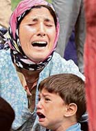 Kashmiri villagers weep during the funeral of two suspected militants in Khrew, south of Srinagar