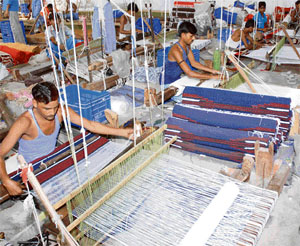 Weavers at work in a handloom unit in Panipat. The number of units in the district is gradually declining
