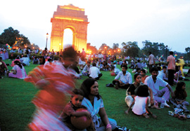 Delhiites spend their time on a sweltering evening at the India Gate in the Capital.