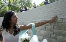 Natasha Madon is overcome with emotion while pointing out her fathers name on the Air India Memorial in Vancouvers Stanley Park on Friday. Madons father, Sam Madon, was on Air India Flight 182 when a bomb exploded on board.