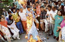Shimla BJP members burn an effigy of former transport and tourism minister G.S. Bali in front of the deputy commissioners office in Shimla on Monday.