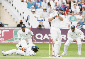England batsman Andrew Strauss (2ndR) looks on as India wicket keeper Mahendra Singh Dhoni (2ndL) celebrates catching him for 55 runs at Trent Bridge in Nottingham, central England during the fourth day of the second cricket Test on Monday.