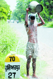 This man seems to be enjoying his roadside splash near Adampur in Jalandhar on Tuesday. 