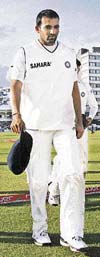 India's Zaheer Khan (R) is applauded off the pitch by team mates at Trent Bridge in Nottingham.