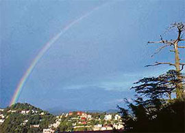 A captivating view with a rainbow in the background after rain in McLeodganj on Wednesday.