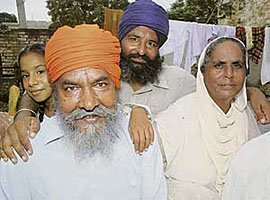 Naseeb Singh, along with his son Harmanjit and wife Avtar Kaur, at his native village Jhingran Kalan on Wednesday. 
