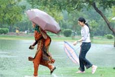 Girls enjoy rain at Boat Club in the Capital on Thursday. 