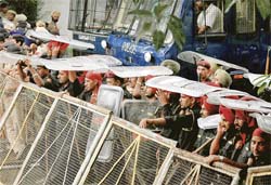 Policemen use their shields as a protection against rain at a rally by the Youth Shiromani Akali Dal (Mann) in Chandigarh on Friday.
