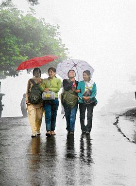 These college girls seem to enjoy rain that lashed Shimla on Friday, cooling the weather. The state capital recorded the minimum temperature of 16.5C.