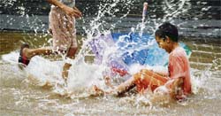 Boys enjoy the rain on the Panjab University campus, Chandigarh
