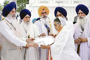 Daljit Kaur, widow of Bhai Jasbir Singh Khalsa, receives the Panth Rattan award from the Dharam Parchar Committee of the SGPC in Amritsar on Saturday.