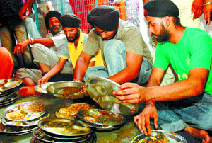 Three bikers, arrested by police for breaking law, perform kar-sewa (community service) at Bangla Sahib Gurdwara following the court orders in the Capital