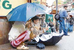 An umbrella repairer on his job at Shimla on Sunday.