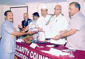 Kuriakose V.K, principal, Jhamku Devi Senior Secondary School, Abohar, receives the Jewel of India award from former CEC G.V.G.Krishnamurthy and former Governor Dr Bhisham Narain Singh in New Delhi