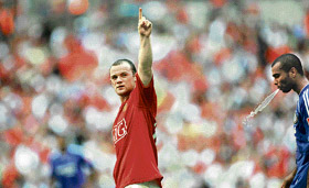 Manchester Uniteds Wayne Rooney (left) gestures as Chelseas Ashley Cole spits during the FA Community Shield football match at Wembley Stadium