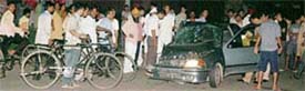 A crowd gathers around a car that met with an accident at the Sector 15-16 trafficlights in Chandigarh on Sunday night.