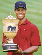 Tiger Woods holds the trophy after winning the WGC Invitational Golf Tournament at the Firestone Country Club in Akron, Ohio