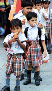 Schoolchildren have ice-cream at Appu Ghar in the Capital on Tuesday.