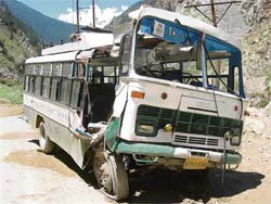 The ill-fated HRTC bus damaged by a boulder.