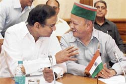 Union finance minister P. Chidambaram in conversation with Himachal Pradesh Chief Minister Virbhadra Singh during the signing of legal documents of the HP state road project between the Government of India and the World Bank in New Delhi