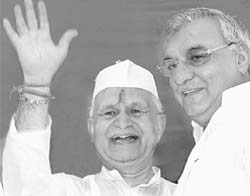 Haryana Congress president Phool Chand Mullana (left) waves to his supporters after taking over his new assignment in Chandigarh
