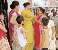 A candidate goes from door to door in her last-ditch efforts to woo voters in Ludhiana on Tuesday.