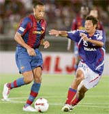 Spanish FC Barcelona forward Thierry Henry of France (L) controls the ball as Japan's Yokohama F. Marinos midfielder Ryuji Kawai tries to intercept during their friendly match as part of Barcelona's Asian tour in Yokohama, on Tuesday. FC Barcelona won 1-0.