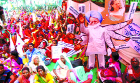 Activists from the Akhil Bhartiya Prgatisheel Mahila Association stage a dharna against the UPA government near Parliament in the Capital on Wednesday
