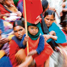A child holds aloft the CITU banner of revolt in front of the deputy commissioner's office in Shimla on Wednesday.