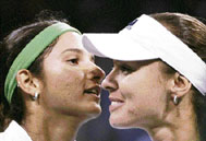 Sania Mirza of India (left) gets a hug after winning her match against Martina Hingis of Switzerland in the East West Bank Classic tennis tournament in Carson, Calif., Tuesday.