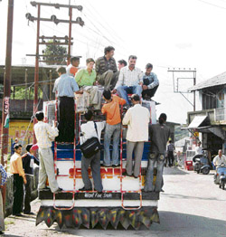 Commuters perch precariously on a bus on its way to Palampur from Dharamsala on Thursday, putting their lives to great risk.