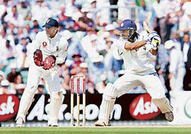 Mahendra Singh Dhoni plays a shot off the bowling of Englands Monty Panesar as wicketkeeper Matt Prior looks on during the second day of the third Test at the Oval on Friday.