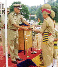 DIG D.S. Minhas honours the best working police employee at the passing out parade at the PTC, Daroh, in Dharamsala on Saturday.