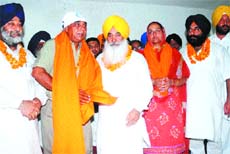 Akali leader Sewa Singh Sekhwan welcomes independent councillors Gurmeet Singh and Raminder Kaur Dhindsa into SAD in Jalandhar on Sunday.
