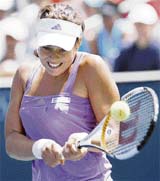 Serbias Ana Ivanovic hits a return to compatriot Jelena Jankovic during the semifinals of the WTA tennis tournament in Carson, California, on Saturday. Ivanovic won 4-6, 6-3, 7-5. 